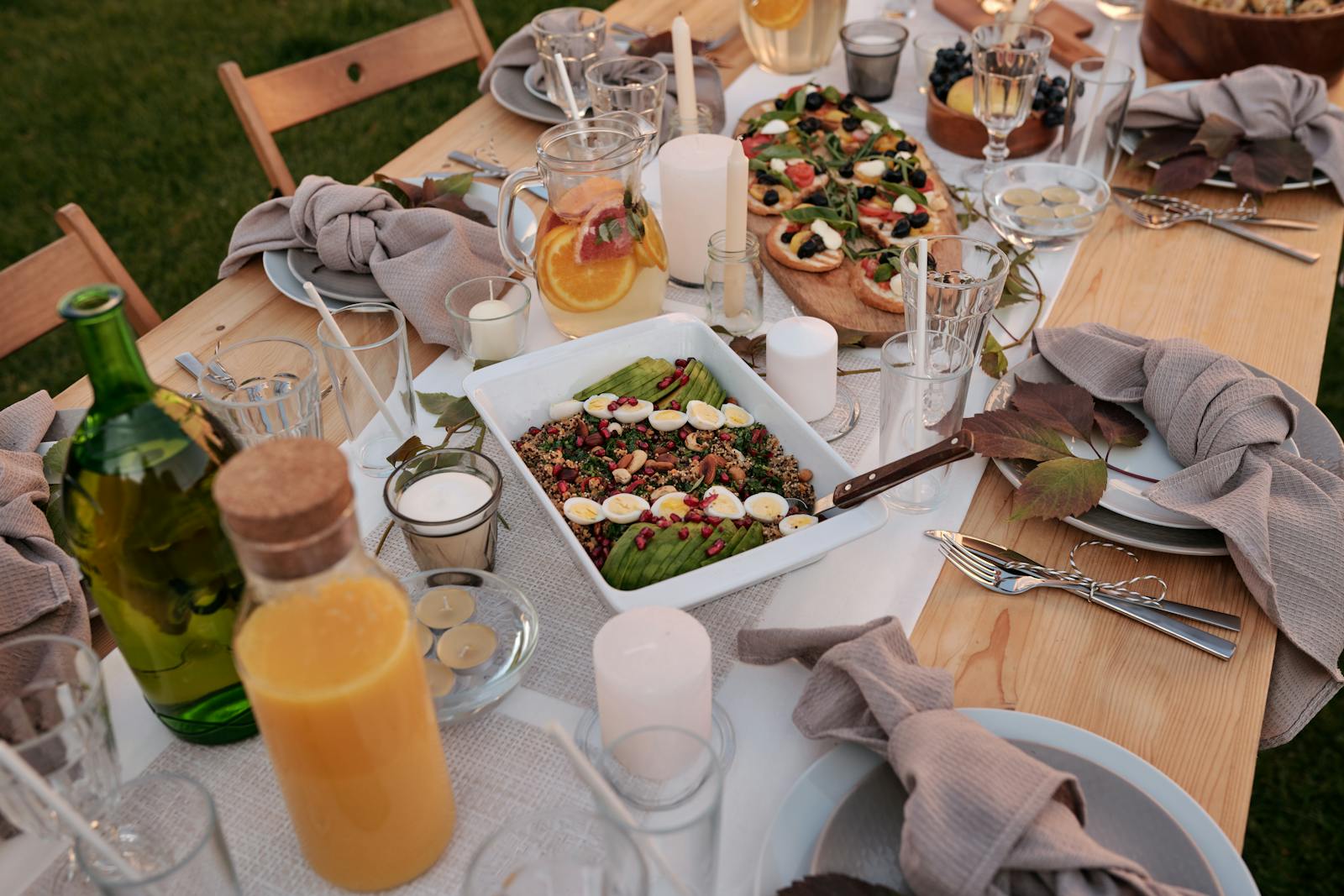 The full vancroft team at the long table — Sunday lunch under the wisteria, eight people, two dogs, the rest of the meal still to come.