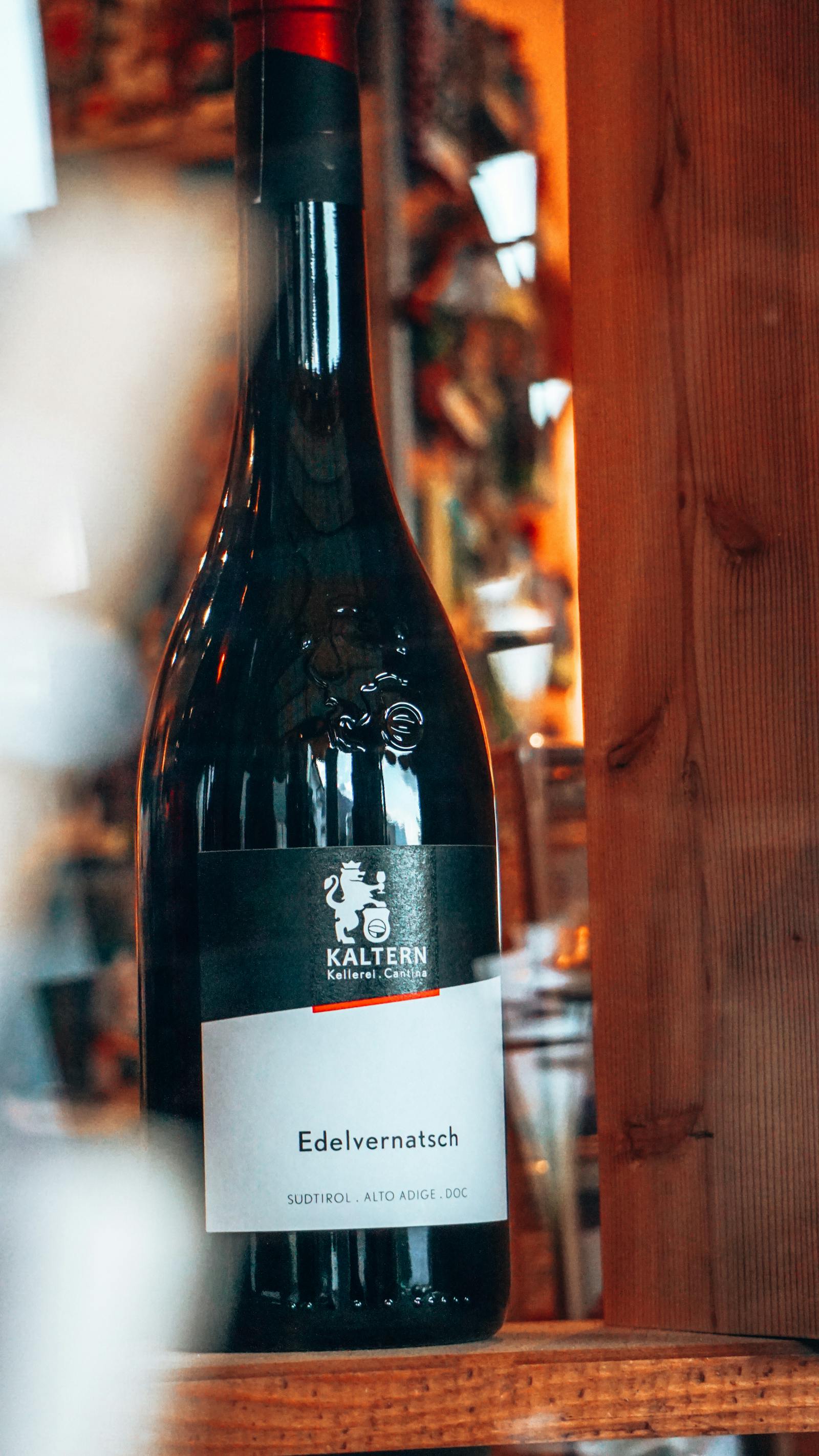 A library bottle of vancroft Reserva 2018, dusty in a stack of horizontal cellar bottles.