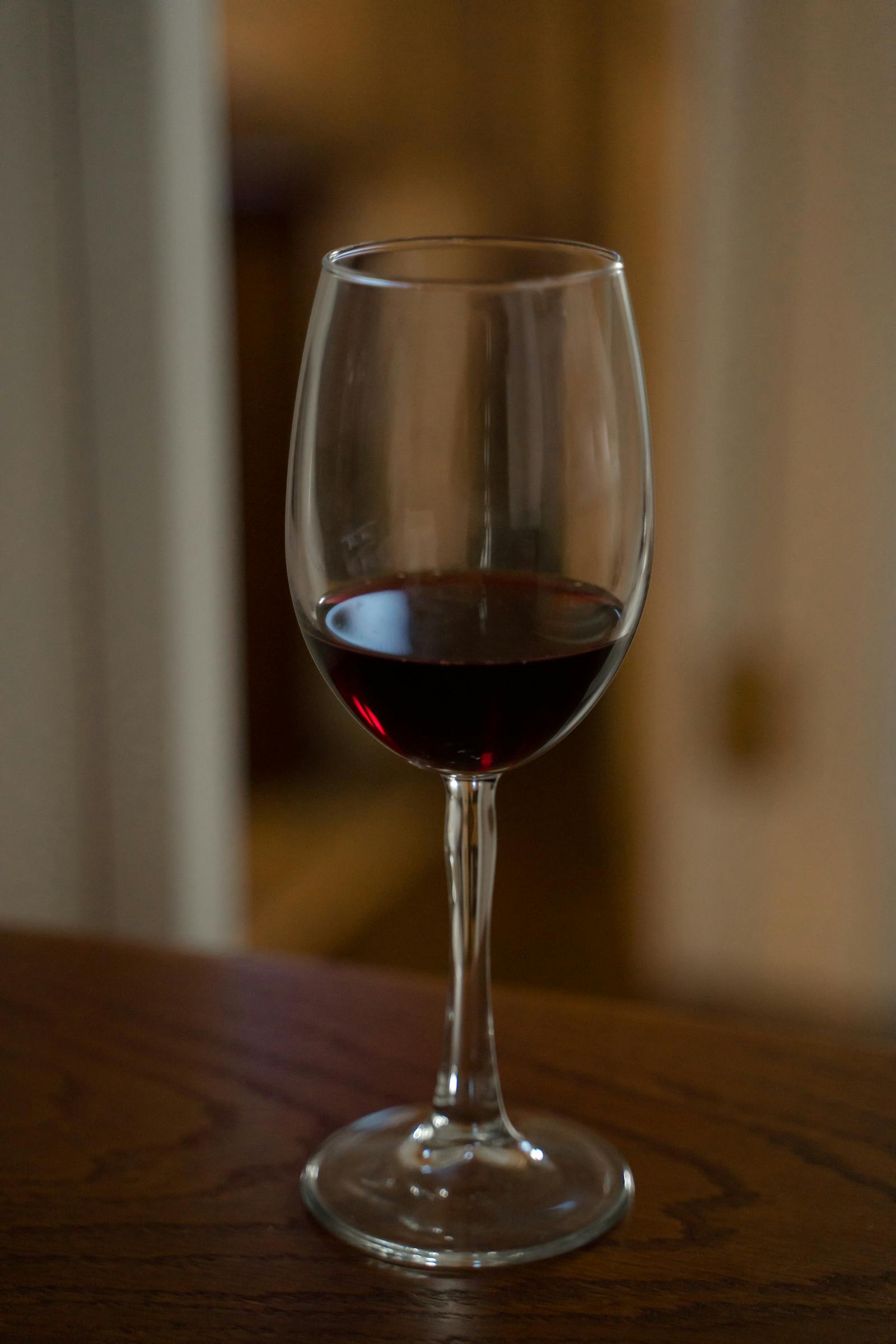 vancroft Estate Malbec 2022 — a single glass on a slate counter.